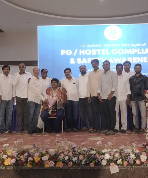 PG Association members on stage at a PG and hostel safety awareness event in Bengaluru